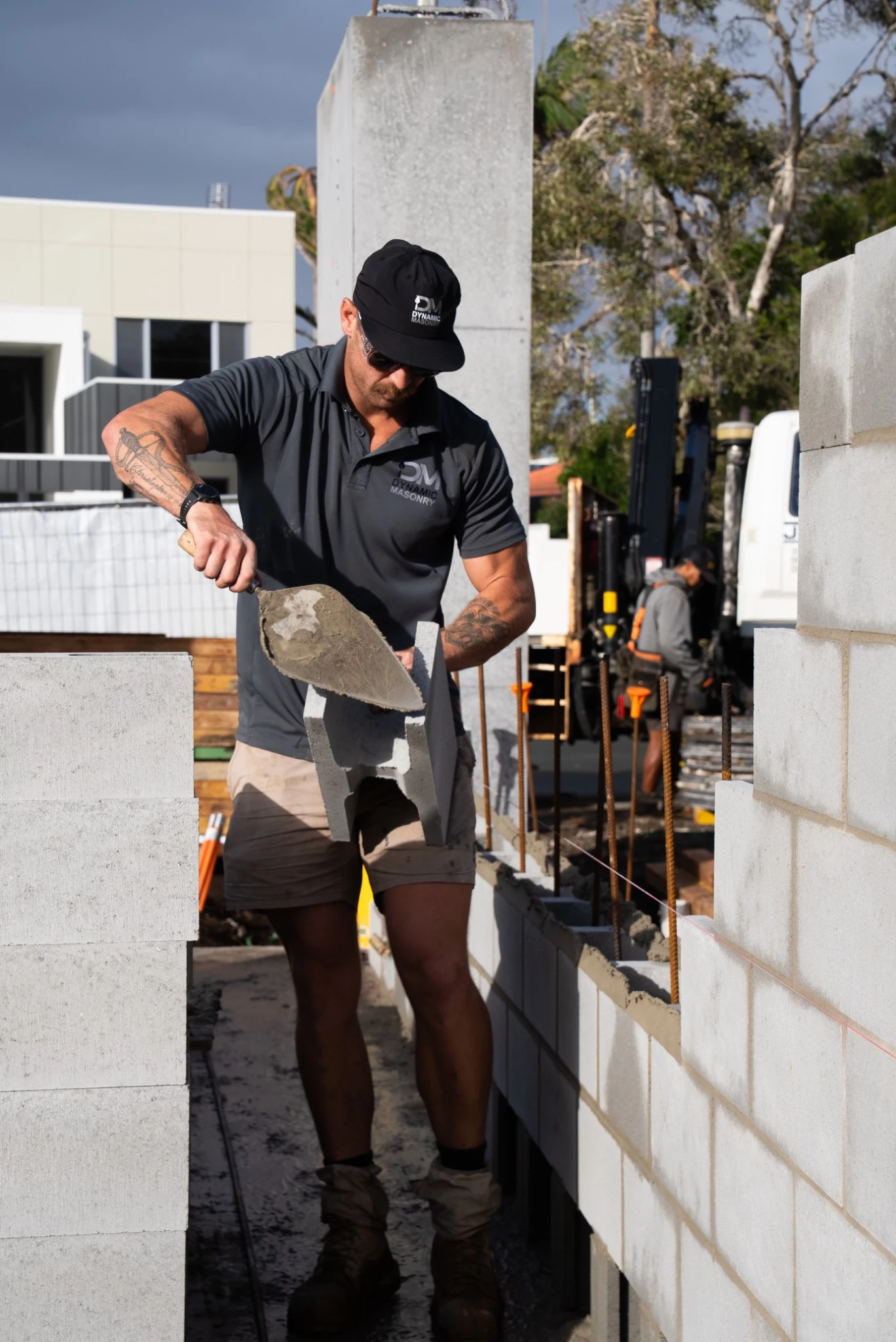 Daniel Dole laying blocks on site in Buddina
